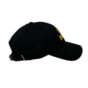 A black hat with a yellow logo on it