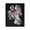 A skeleton and bride kissing on the cheek.