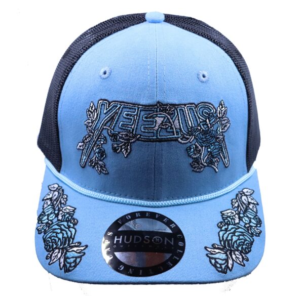 A light blue hat with black and white design.