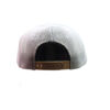 A white hat with a brown leather strap on top of it.