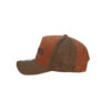 A brown and orange hat is on the ground