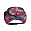A pink and black hat with blue lettering