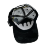 A black and white hat with a skull on it