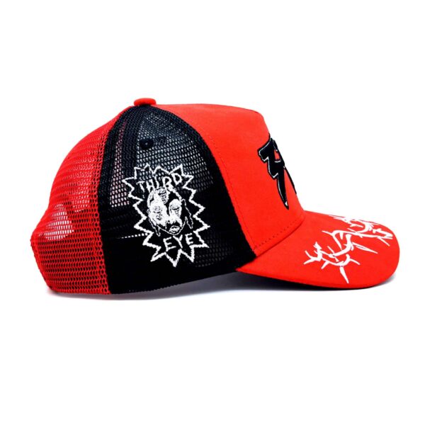 A red and black hat with a skull on it
