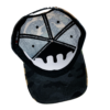 A black and white hat with a design on it