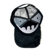 A black and white hat with a face on it.