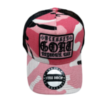 A pink and white camo hat with a patch on it.