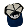 A baseball cap with the image of a bat on it.