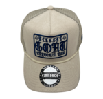A tan hat with a patch on the front of it.