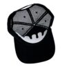 A black hat with an open face and a white skull on the front.