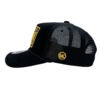 A black hat with a yellow patch on the side of it.