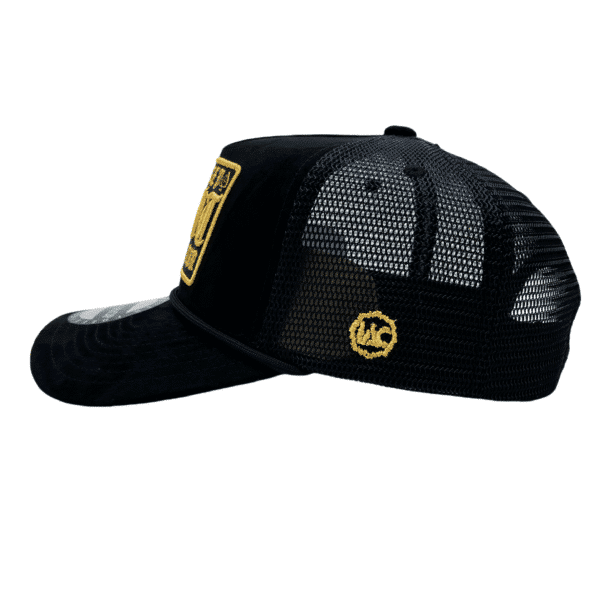 A black hat with a yellow patch on the side of it.