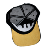 A black and white hat with a yellow brim