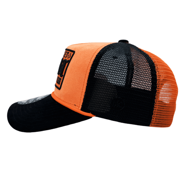 A black and orange hat with an image of a person.