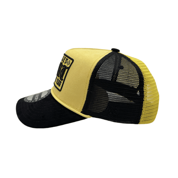 A yellow and black hat with a patch on it