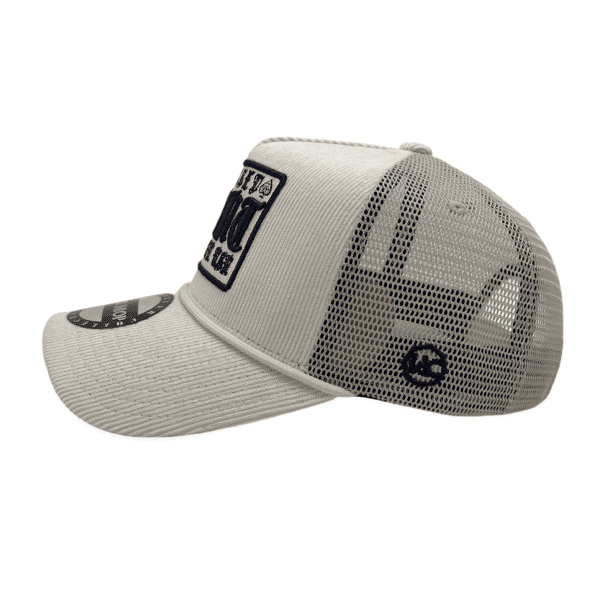 A white hat with a patch on the side of it.
