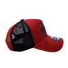 A red hat with black mesh on top of it.