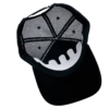 A black hat with an open face and a white logo.