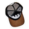 A baseball cap with an upside down face on it.