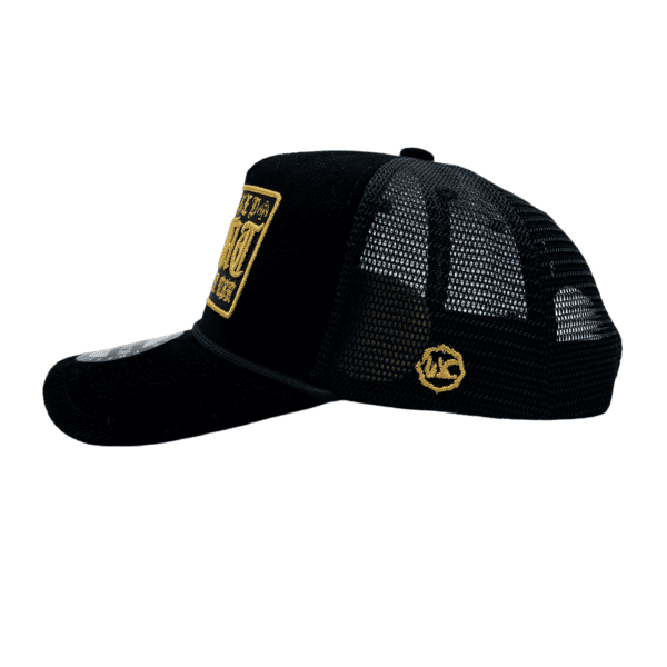 A black hat with a yellow patch on the side of it.