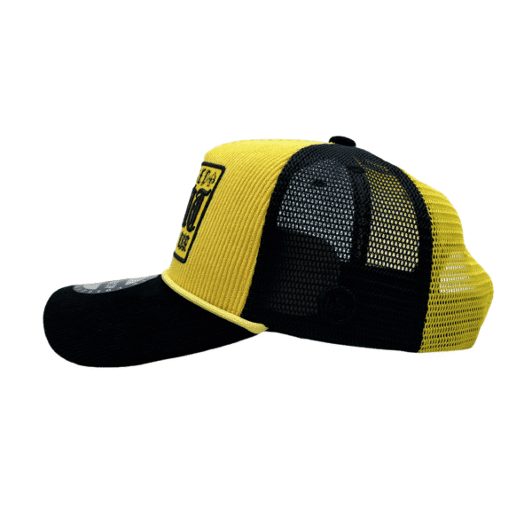 A yellow and black hat with a patch on it