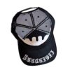A black and white hat with a design on it.
