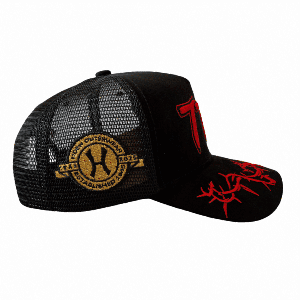 A black hat with red and gold logo on it.