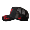 A black and red hat with a logo on it.
