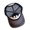 A hat with a dripping logo on it.